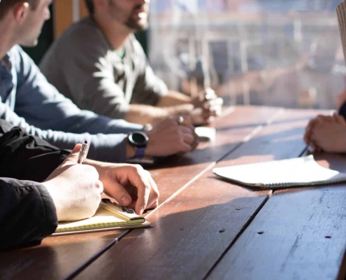 Plusieurs personnes en train de dialoguer autour d'une table